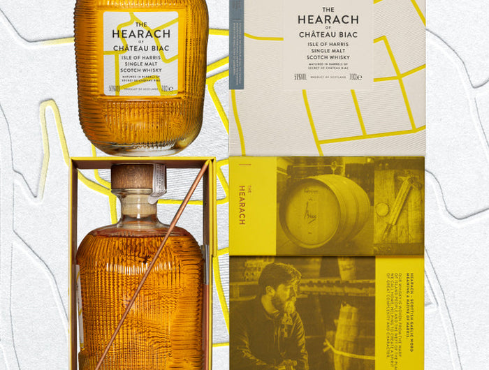 Two bottles of Hearach Chateau Bar whiskey with a decorative box on a white background.