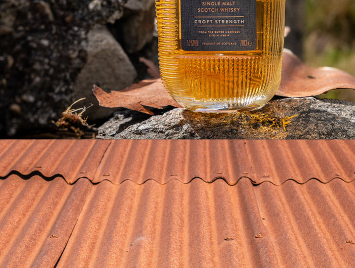 Bottle of Hearach whisky on a rustic surface with natural background