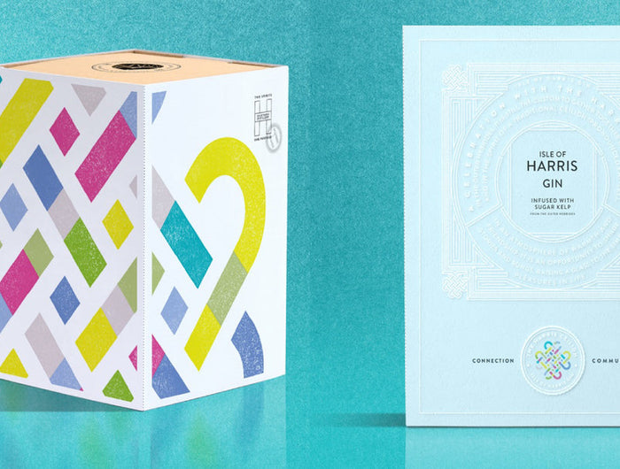 Pink Harris Ceilidh Gin bottle and colorful packaging on a teal background