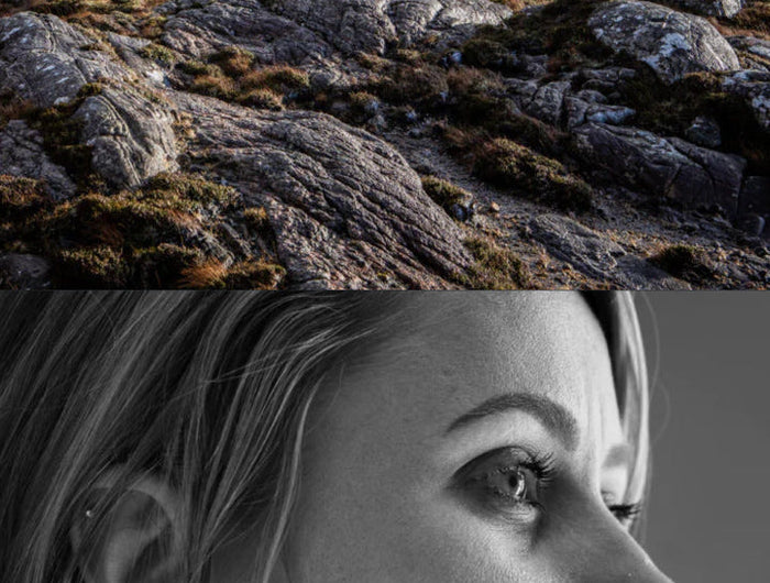 Top half of the image shows a rocky landscape with grass, and the bottom half is a black and white profile photo of a woman.