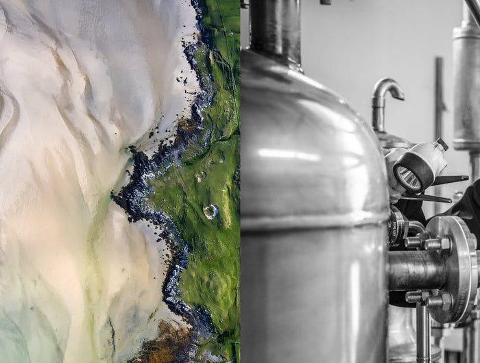 Person working with brewing equipment in a brewery setting